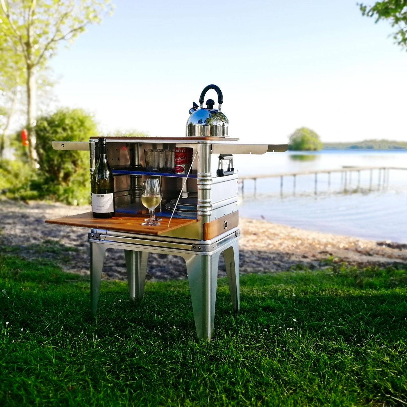 DOCK kitchen open with kettle and wine at a lakeside sunset