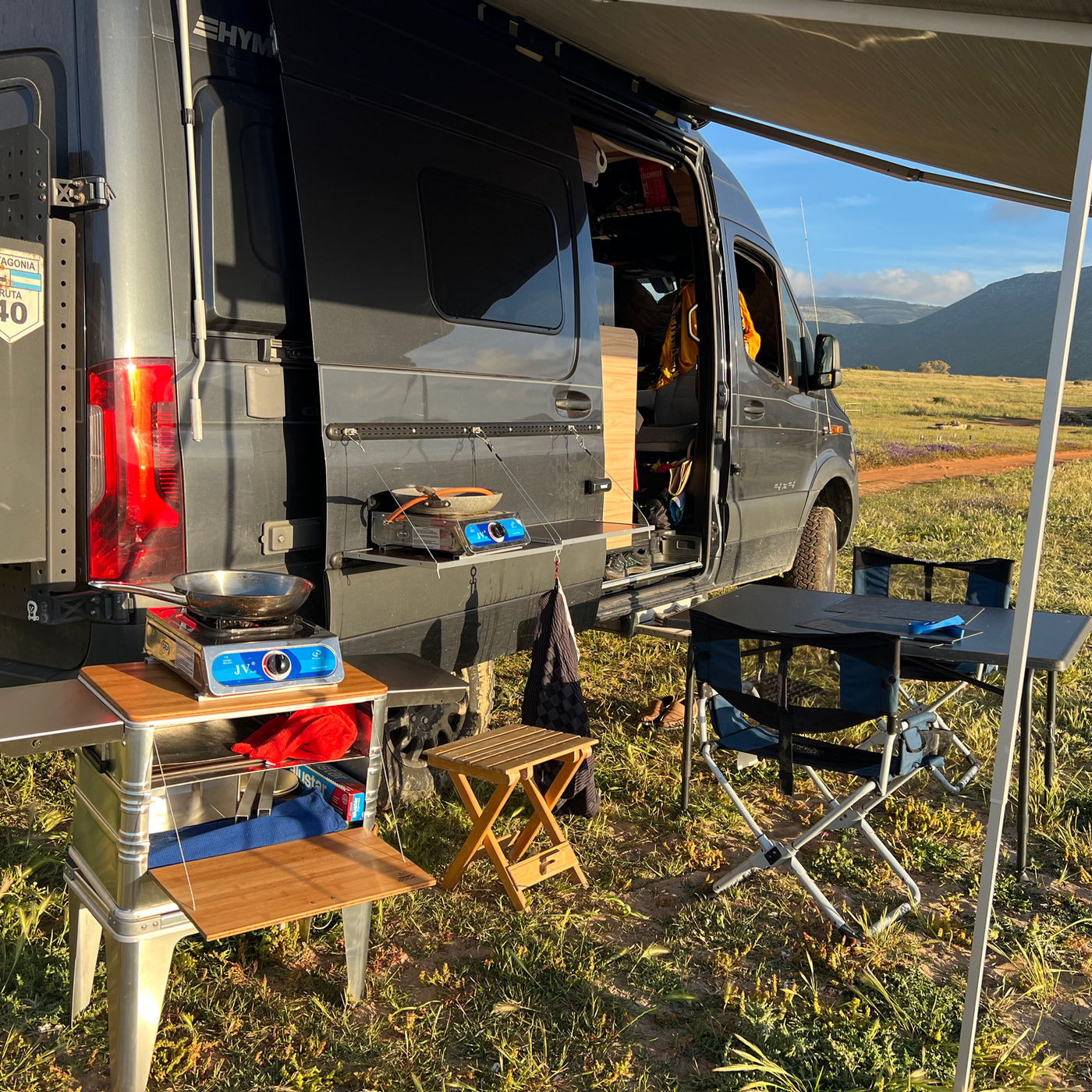 DOCK kitchen at the back of a 4x4 Hymer van at golden hour